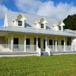 New residential home exterior with lawn, showcasing neighborhood architecture and construction.